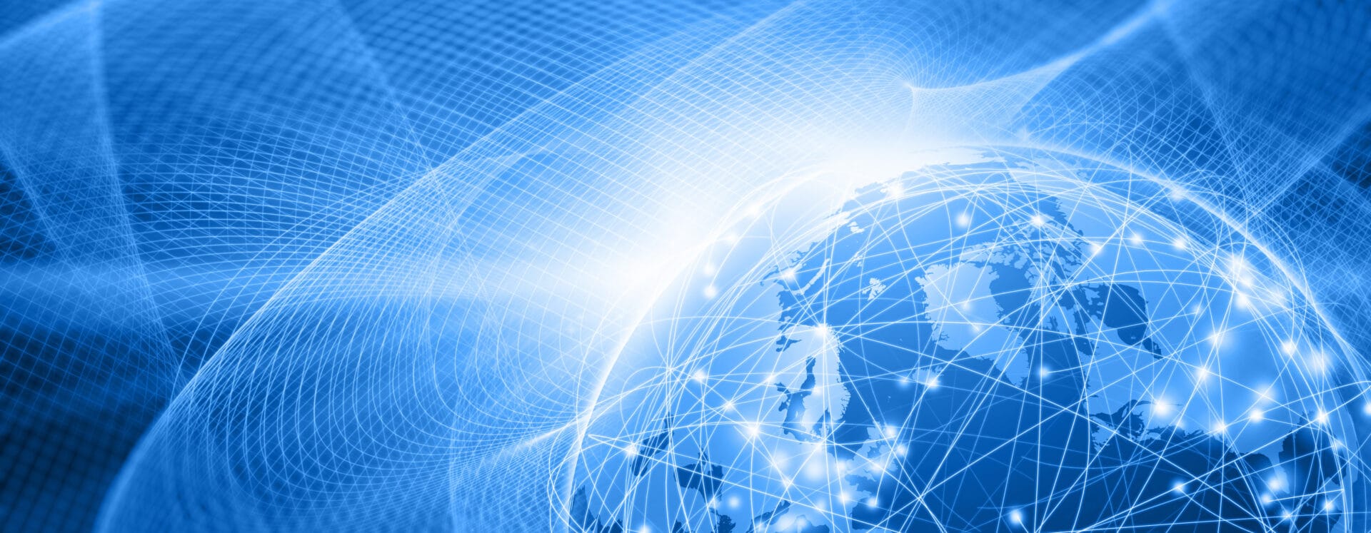 Planet Earth floating in the outer space surrounded by a complex computer network of glowing nodes connected by bright lines: global business and technology connect everything with the Internet of Things. The blue space is filled by an abstract waving wired mesh showing a magnetic field that connects everything. Dark blue background. Planet Earth is in the left side, with NOrth America and Europe on top and copy space on left side. Wide angle horizontal image, letterbox format. - IMD Business School