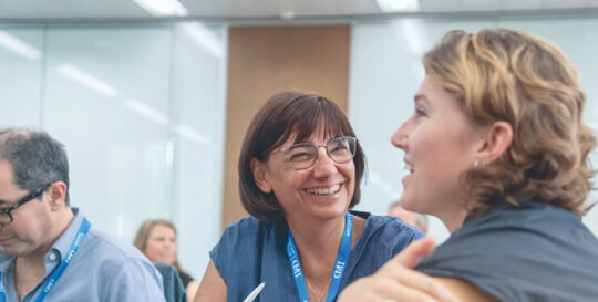 Two women participants having an in-class discussion - IMD Business School