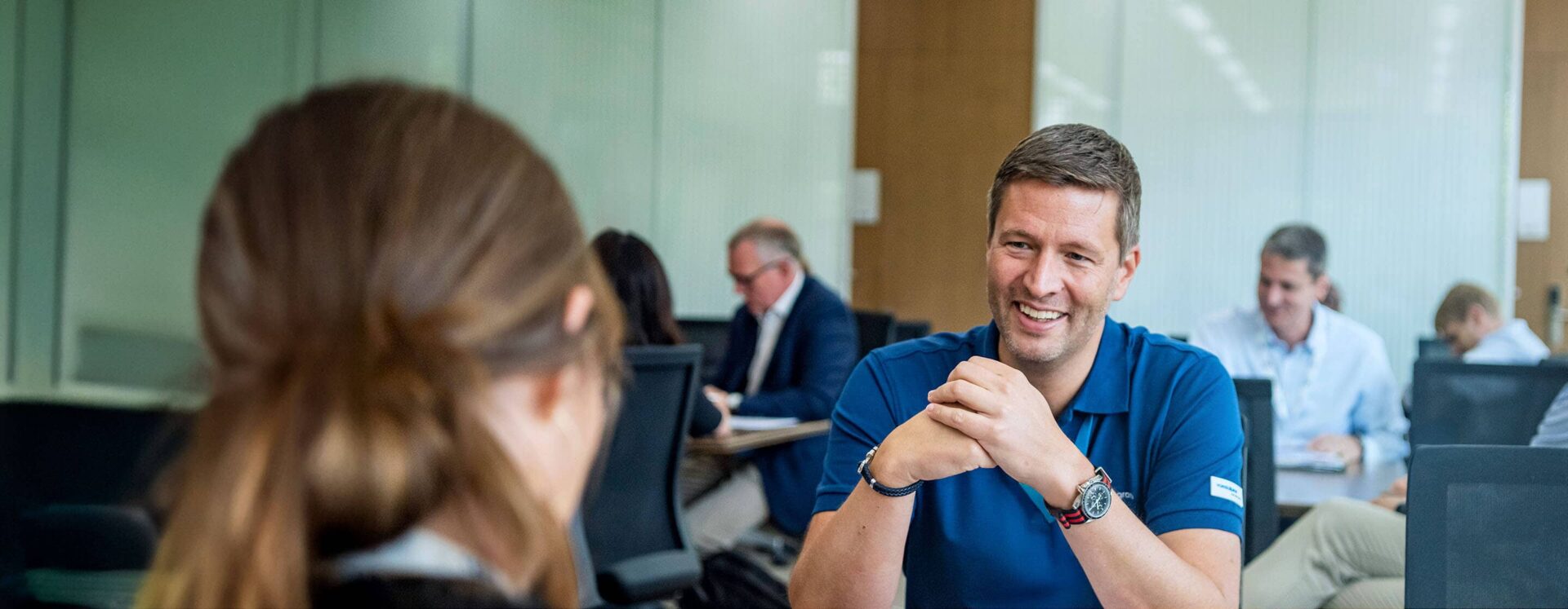 Group of business professionals in discussion during a sustainability-focused executive education program at IMD - IMD Business School